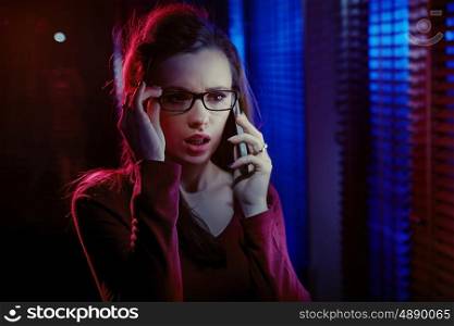 Portrait of an inquisitive young woman talking on the phone