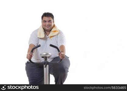 Portrait of an obese man exercising over white background
