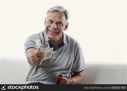 Portrait of an old man offering money