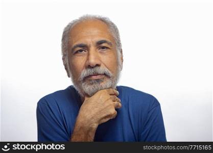 PORTRAIT OF AN OLD MAN POSING IN FRONT OF CAMERA