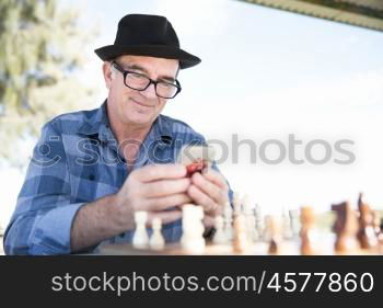 Portrait of an old man with his mobile phone outdoors. Old man with his mobile