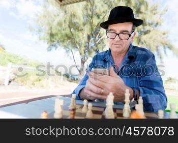 Portrait of an old man with his mobile phone outdoors. Old man with his mobile