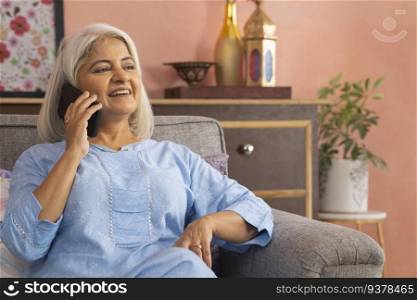 Portrait of an old woman talking on mobile phone