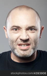 portrait of angry man isolated on gray background