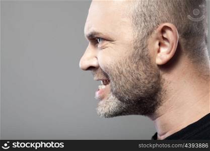 portrait of angry man isolated on gray background with copyspace