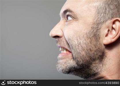 portrait of angry man isolated on gray background with copyspace