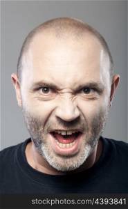 portrait of angry man screaming isolated on gray background