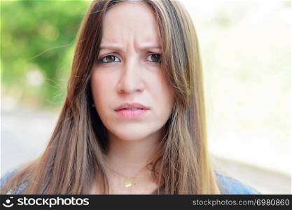 Portrait of angry young latin woman. Outdoors