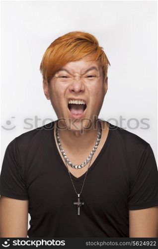 Portrait of angry young man with mouth open