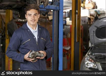 Portrait Of Apprentice Mechanic In Auto Repair Shop