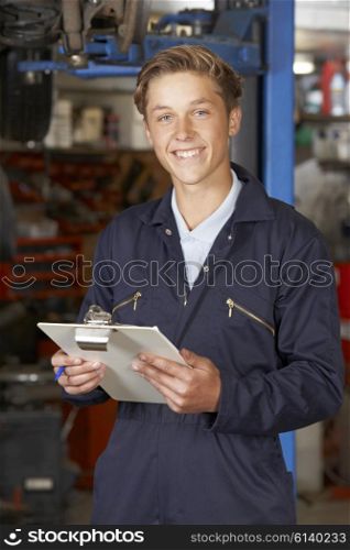 Portrait Of Apprentice Mechanic In Auto Repair Shop