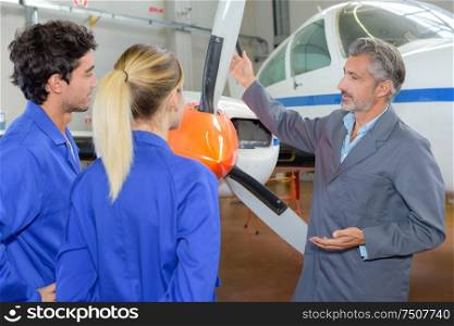 portrait of apprentices and propeller of an airplane