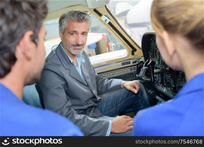 portrait of apprentices during lesson inside a vehicle
