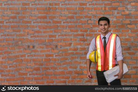 portrait of architect builder in front of brick wall with copy space. portrait of architect builder