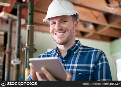 Portrait Of Architect Inside House Being Renovated Using Digital Tablet