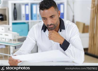 portrait of architect looking at camera in office