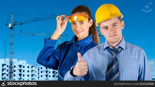 Portrait of architects at in front of construction site, building and crane.