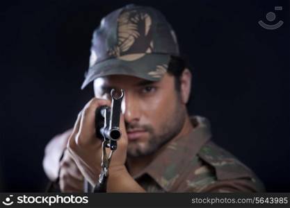 Portrait of army man aiming with a rifle