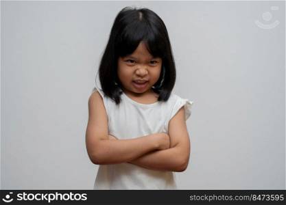 Portrait of Asian angry and sad little girl on white isolated background, The emotion of a child when tantrum and mad, expression grumpy emotion. Kid emotional control concept