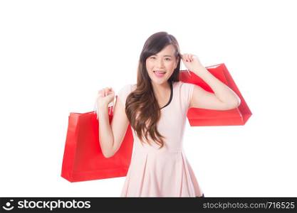 Portrait of asian beautiful young woman holding shopping bag with smile and happy, girl with buying on isolated white background, consumerism concept.