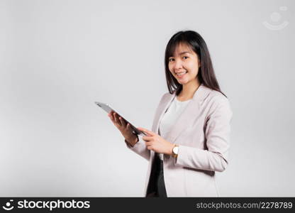 Portrait of Asian beautiful young woman smiling using tablet computer, Happy lifestyle female teen touching screen on digital tablet pc, studio shot isolated on white background