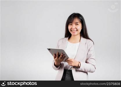 Portrait of Asian beautiful young woman smiling using tablet computer, Happy lifestyle female teen touching screen on digital tablet pc, studio shot isolated on white background
