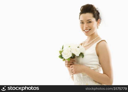 Portrait of Asian bride with bouquet.