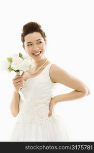 Portrait of Asian bride with bouquet.