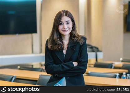 Portrait of asian businesswoman in casual suit standing in smile action in modern office or meeting room or seminar room, Business owner and entrepreneur concept
