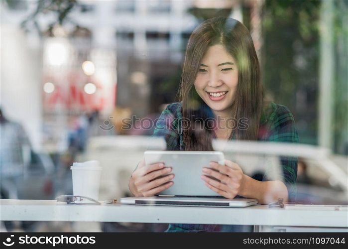 Portrait of asian businesswoman in casual suit using technology laptop for working in happiness action at the desk beside the glass in modern office, Business owner and entrepreneur concept