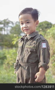 portrait of asian children wearing airforce pilot suit toothy smiling face