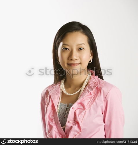 Portrait of Asian Chinese mid-adult female smiling and looking at viewer.