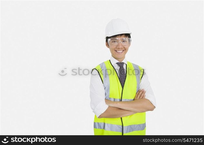 Portrait of Asian construction worker with arms crossed over white background