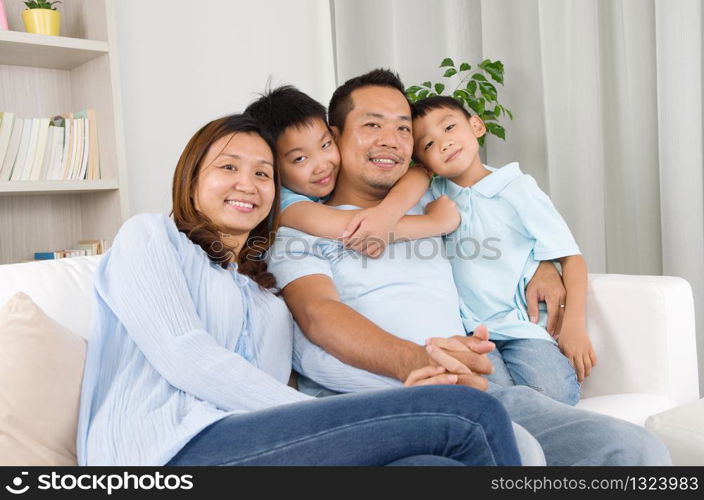 Portrait of asian family sitting on sofa