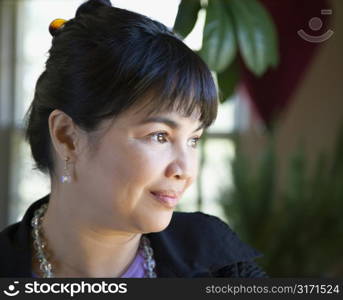 Portrait of Asian Filipino woman looking to the side.