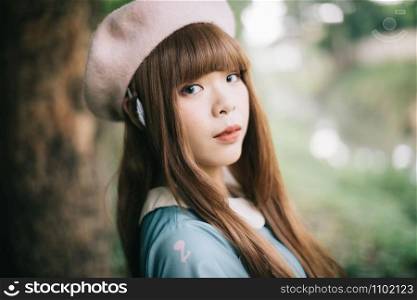 Portrait of asian girl in lolita fashion dress in garden background