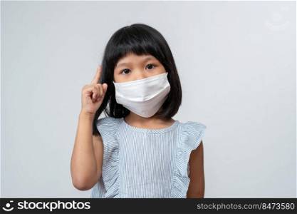 Portrait of Asian girl kid with protective face mask ready for new school year with pandemic restrictions. Concept of kid going back to school and new normal lifestyle