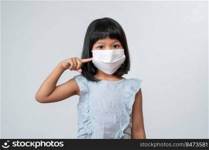 Portrait of Asian girl kid with protective face mask ready for new school year with pandemic restrictions. Concept of kid going back to school and new normal lifestyle