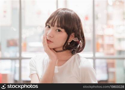 portrait of asian girl with white shirt looking at night outdoor bokeh
