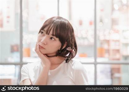 portrait of asian girl with white shirt looking at night outdoor bokeh