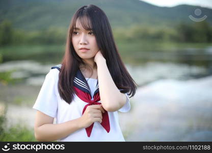 Portrait of asian japanese school girl costume looking at park outdoor