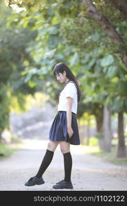 Portrait of asian japanese school girl costume looking at park outdoor film vintage style