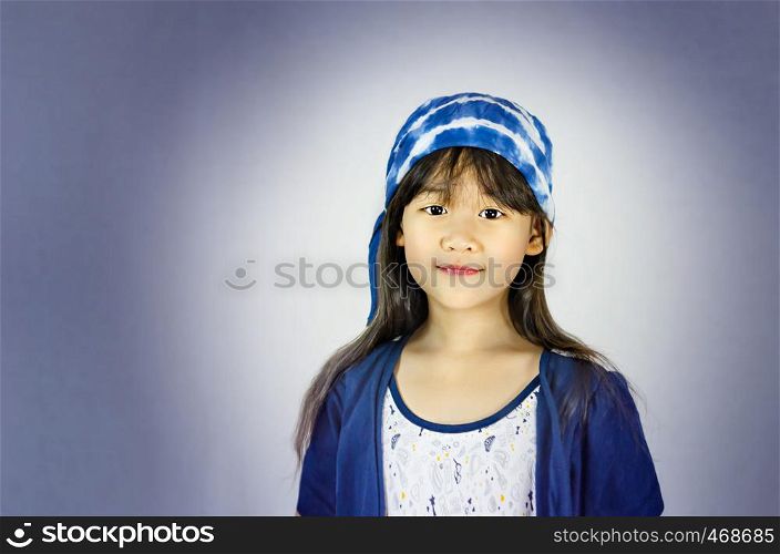portrait of asian little girl in blue and white dress. portrait of asian little girl