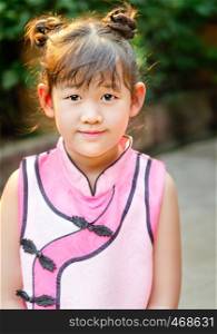 Portrait of asian little girl in pink dress. portrait of asian little girl