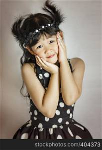 portrait of asian little girl in white and black dress. portrait of asian little girl
