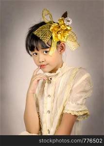 Portrait of asian little girl with golden flower. portrait of asian little girl