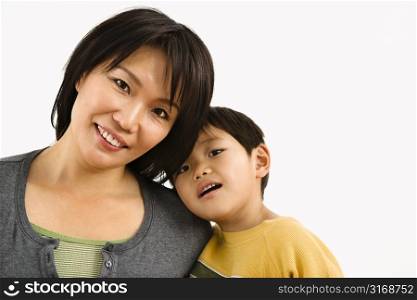 Portrait of Asian mother and young son leaning on eachother.