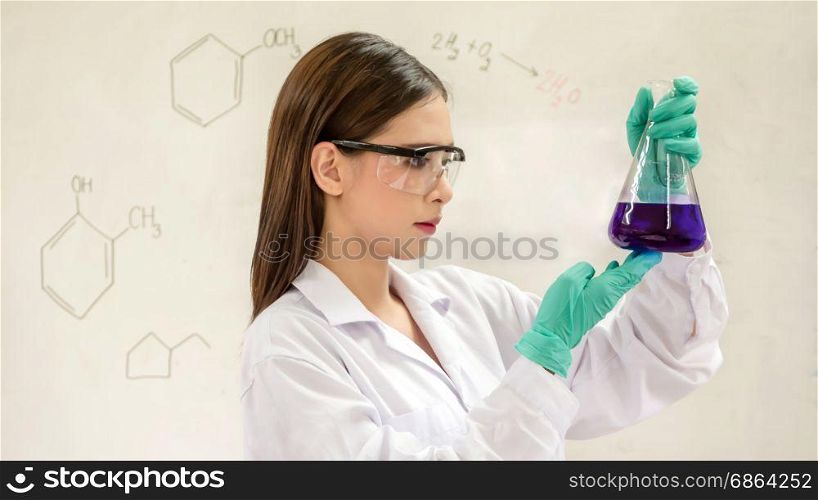 Portrait of Asian scientific researcher holding at a liquid solution in a lab. Portrait of Asian scientific