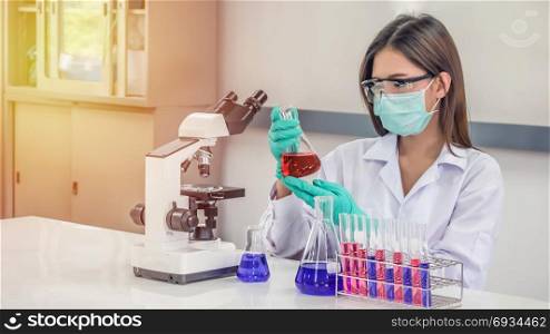 Portrait of Asian scientific researcher working in laboratory. Scientist working at laboratory