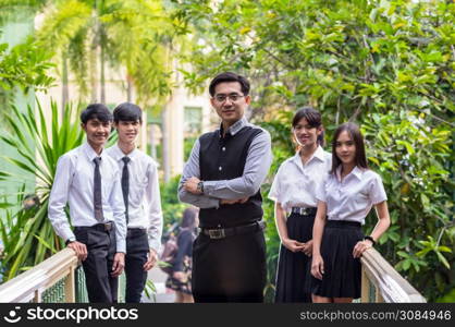 Portrait of Asian teacher and College Students in park, University education concept